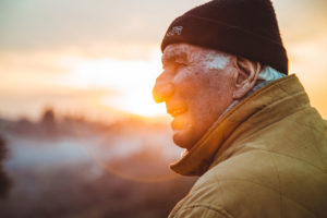 Elderly man in front of sunset