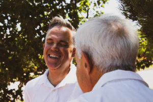 Elderly man and son laughing